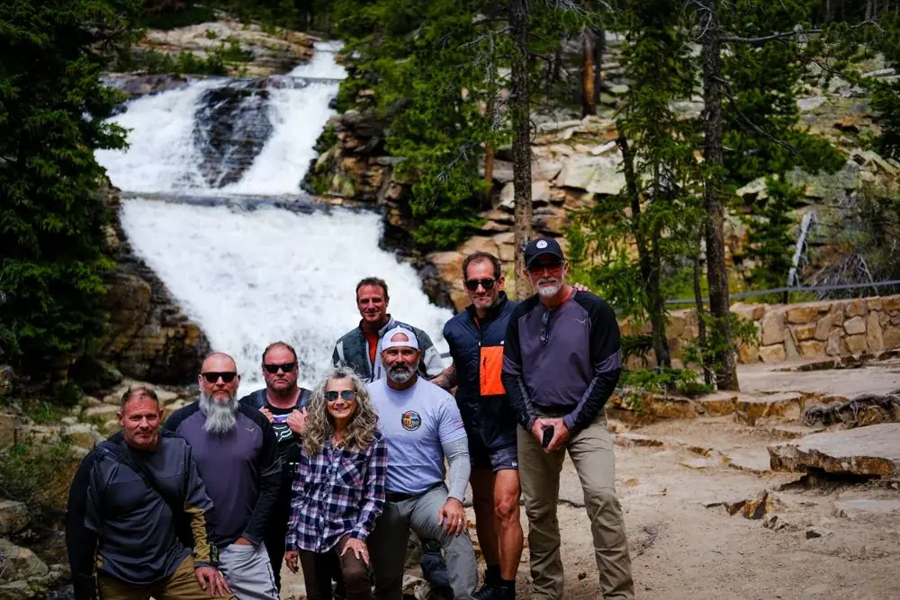SOAF riders gathered at a waterfall