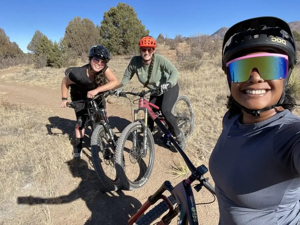 Women mountain biking together